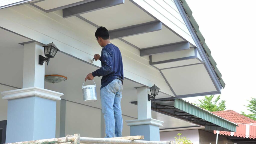 Man Painting Exterior Of A House