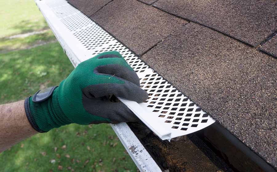 Person Installing Gutter Guards Lg